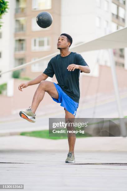 young man playing with soccer ball - juggling stock pictures, royalty-free photos & images