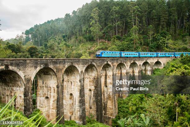 train passing on nine arches bridge, demodara in ella, sri lanka. - sri lanka train stock pictures, royalty-free photos & images