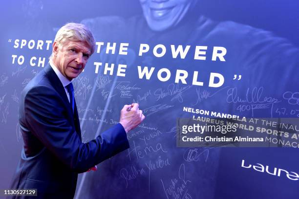Arsene Wenger signs the Nelson Mandela wall during the 2019 Laureus World Sports Awards on February 18, 2019 in Monaco, Monaco.
