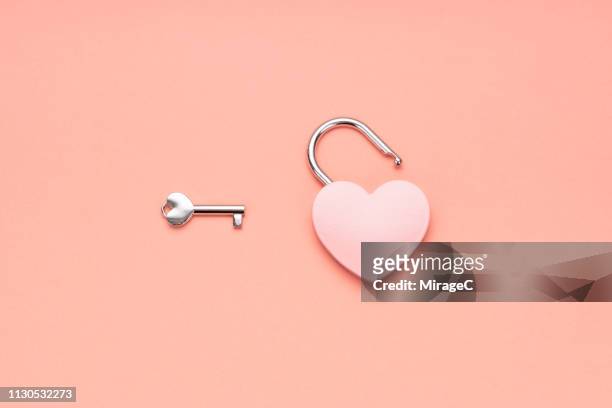 pink heart shape padlock and key - unlocking concept stock pictures, royalty-free photos & images