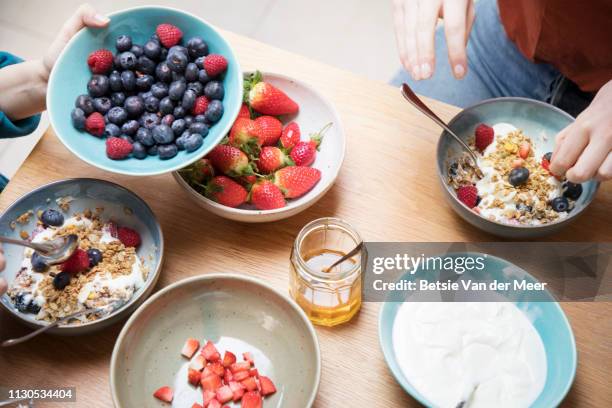 top view of women sharing breakfast at kitchen table. - berry stock pictures, royalty-free photos & images