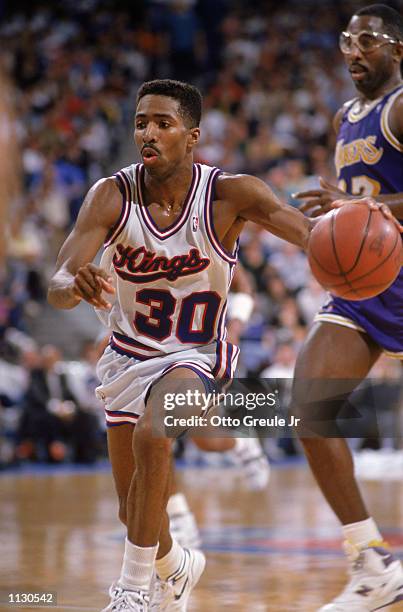 Kenny Smith of the Sacramento Kings dribbles the ball during an NBA game against the Los Angeles Lakers at Arco Arena in Sacramento, California in...