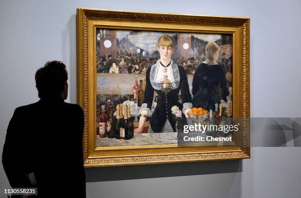 Visitor looks at a painting entitled " A bar at the Folies-Bergere" by Edouard Manet during the opening of "The Courtauld Collection : A Vision For...