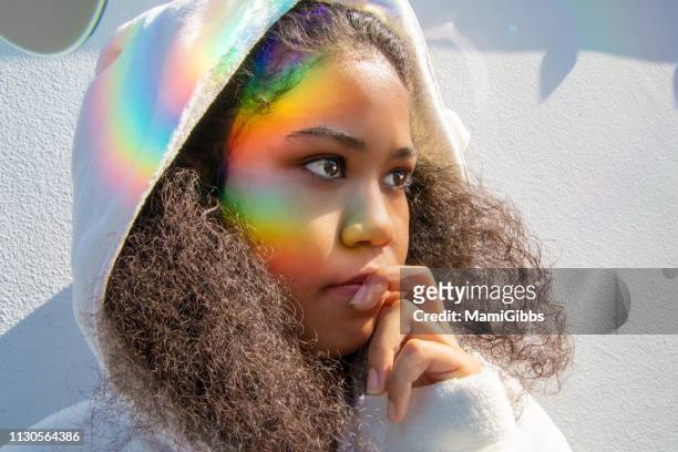 rainbow light reflection on girl's face - hood clothing stock pictures, royalty-free photos & images
