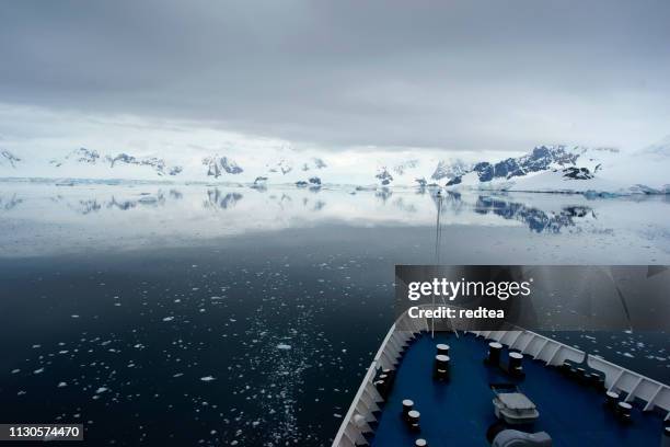 cruise ship crusing around ice floes in antarctic waters - antarctica boat stock pictures, royalty-free photos & images