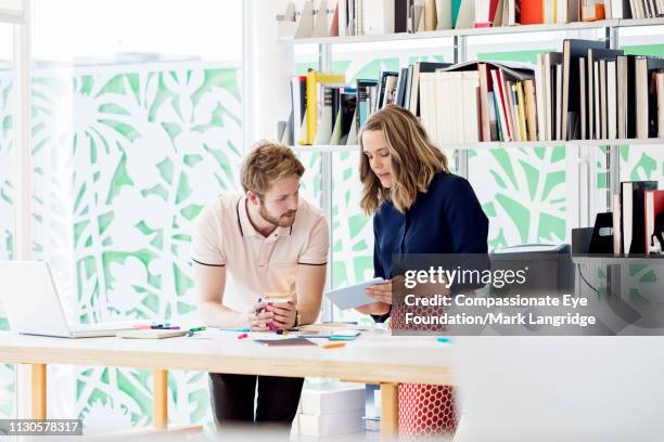 business people using digital tablet in meeting in modern office - man eye cream imagens e fotografias de stock