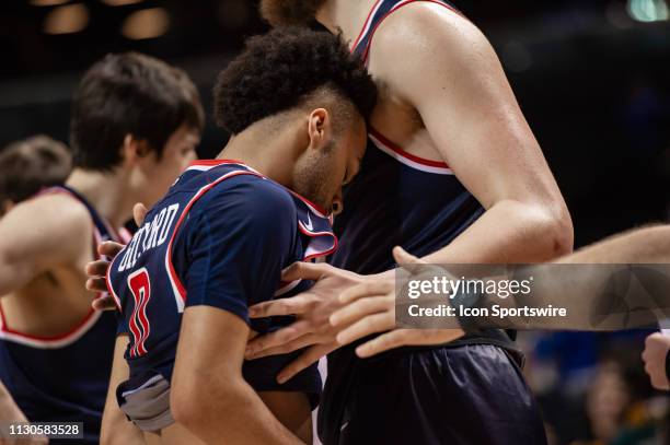 Richmond Spiders guard Jacob Gilyard is consoled by teammates after missing a potential game tying shot at the buzzer during the second half of the...