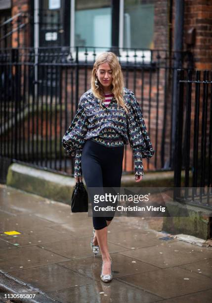 Emili Sindlev is seen wearing cropped leggings, Chanel blouse outside JW Anderson during London Fashion Week February 2019 on February 18, 2019 in...