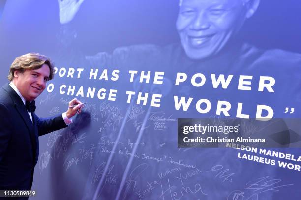 Anton Rupert Jr. Signs the Nelson Mandela wall during the 2019 Laureus World Sports Awards on February 18, 2019 in Monaco, Monaco.