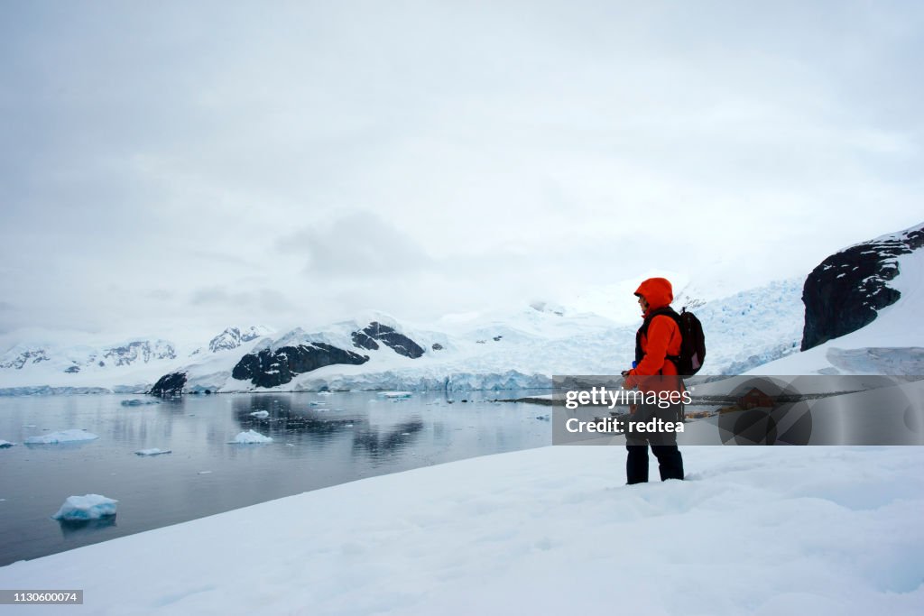 Woman standing Scientific Station Almirante Brown signs Paradise Bay