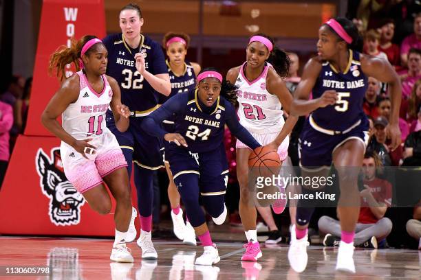 Arike Ogunbowale of the Notre Dame Fighting Irish dribbles up court against the North Carolina State Wolfpack in the second half at Reynolds Coliseum...