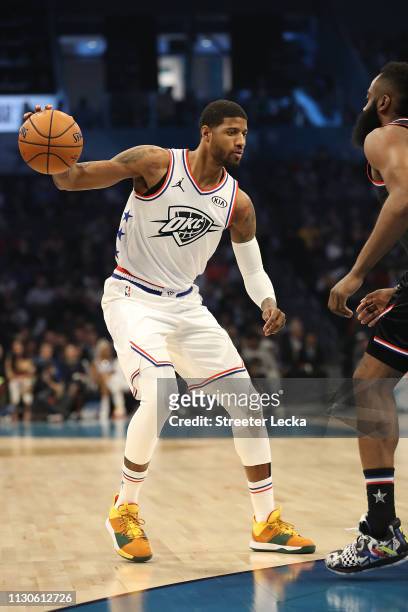 Paul George of the Oklahoma City Thunder and Team Giannis drives against James Harden of the Houston Rockets and Team LeBron during the NBA All-Star...