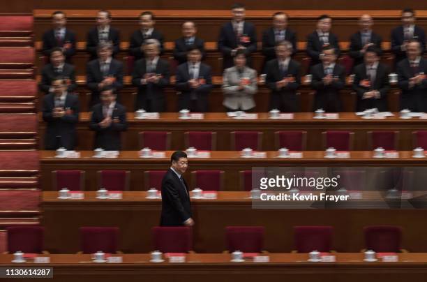 Chinese President Xi Jinping, bottom left, arrives for the closing meeting of the National People's Congress on March 15, 2019 in Beijing, China. The...