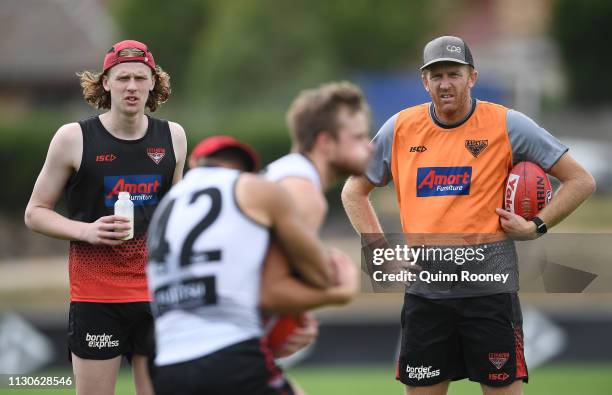 Mason Fletcher and Dustin Fletcher watch on during an Essendon Bombers AFL training session at The Hangar on February 19, 2019 in Melbourne,...