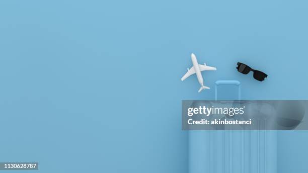 suitcase, minimal travel concept with blue background - multi colored objects stock pictures, royalty-free photos & images