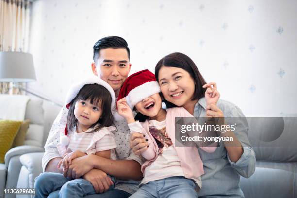 happy asian family celebrating christmas - yongyuan hongkong stock pictures, royalty-free photos & images