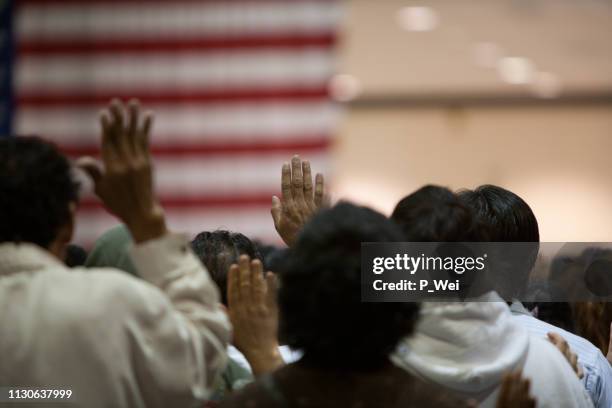 immigrants at a swearing in ceremony - american culture stock pictures, royalty-free photos & images