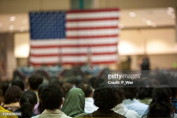 immigrants at a swearing in ceremony - immigration ceremony stock pictures, royalty-free photos & images