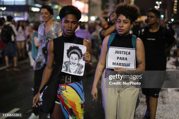 People attend a memorial Mass to mark the one-year death anniversary of slain councilwoman Marielle Franco, at the Candelaria Catholic Church in Rio...
