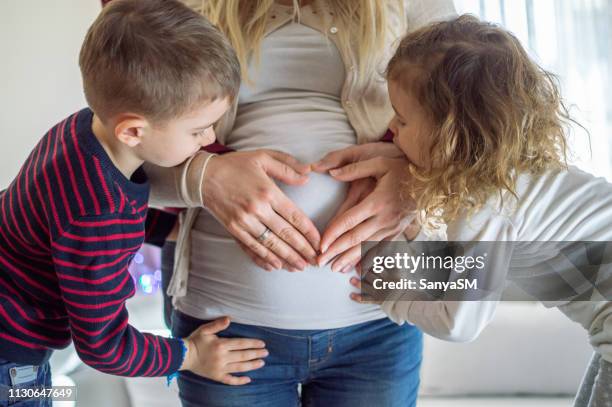 we are waiting for you little one - belly kissing stock pictures, royalty-free photos & images