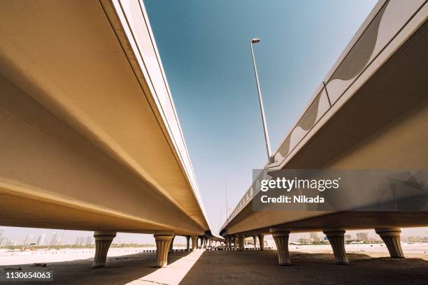 sandy road and bridge in dubai, uae - dubai bridge stock pictures, royalty-free photos & images