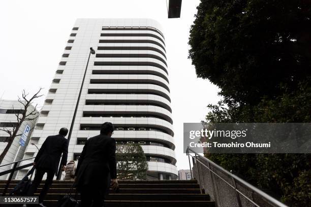 Pedestrians walk in front of the Honda Motor Co. Headqurters on February 19, 2019 in Tokyo, Japan. Honda announced on Tuesday the company plans to...