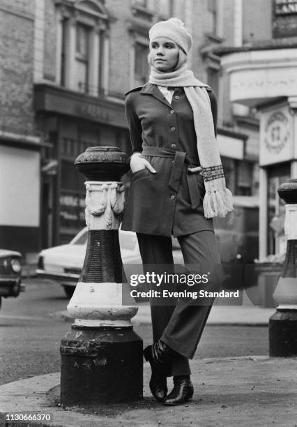 Female fashion model wearing jersey rousers suit with beret and scarf, London, UK, 15th January 1969.