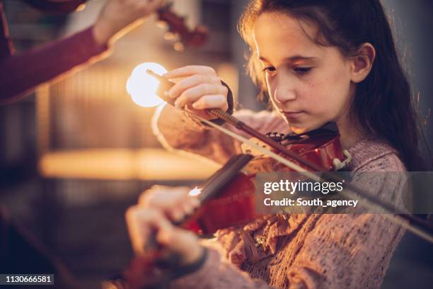 girl playing violin - violin stock pictures, royalty-free photos & images