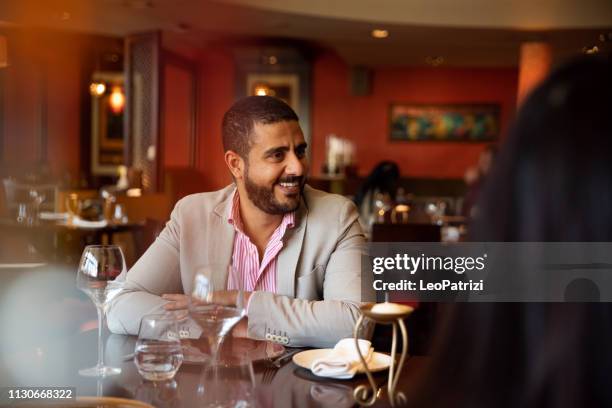 group of multi ethnic arab friends lunch in a restaurant in dubai - emirati enjoy stock pictures, royalty-free photos & images