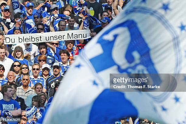 Supporters of Schalke show banners for goalkeeper Manuel Neuer, who announced leaving the club at the end of this season, during the Bundesliga match...