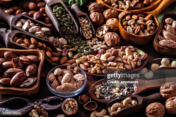 variety of dried fruit and nuts on a table in a old fashioned rustic kitchen - sunflower seed stock pictures, royalty-free photos & images