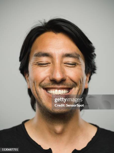 portrait of real hispanic man with happy expression and eyes closed - man eyes closed stock pictures, royalty-free photos & images