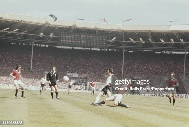 Manchester United defender Jimmy Nicholl clears the ball from David Johnson of Liverpool during play between Liverpool and Manchester United in the...