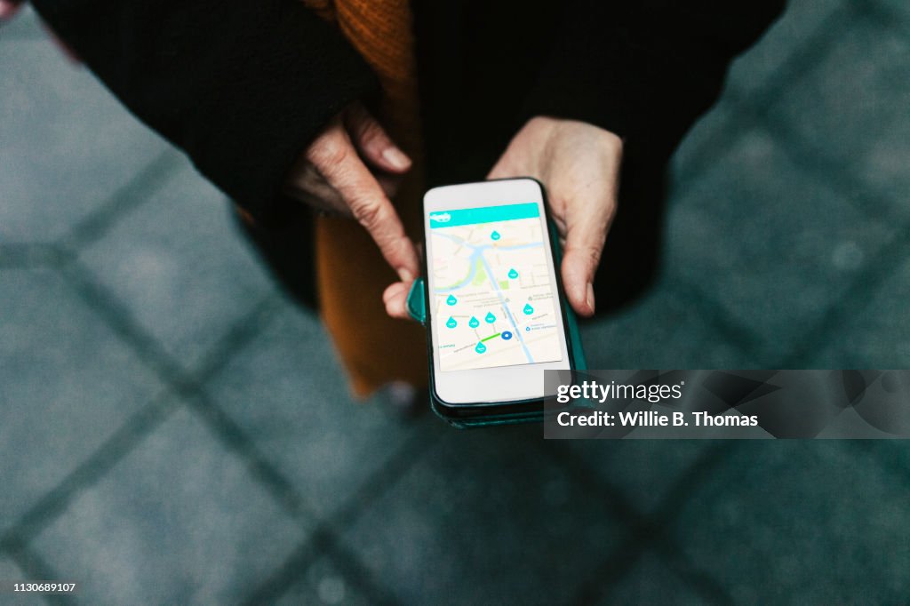 Aerial View On Woman Using Car Sharing App