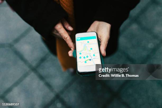 aerial view on woman using car sharing app - car sharing stock pictures, royalty-free photos & images