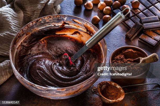 mixing bowl filled with homemade chocolate dough - cake batter stock pictures, royalty-free photos & images