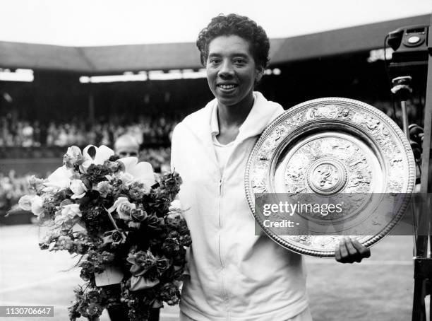 Picture taken on July 5, 1958 at Wimbledon showing American tennis player Althea Gibson after winning the Wimbledon lawn tennis championships. /...