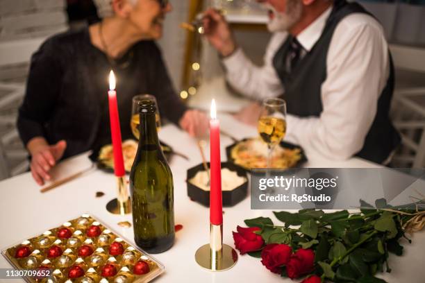 senior couple having romantic dinner - valentines day dinner stock pictures, royalty-free photos & images