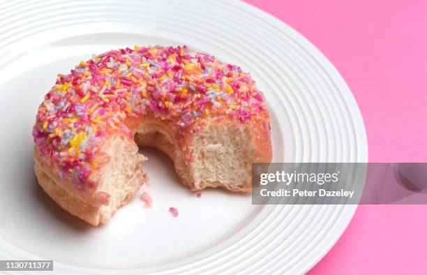 donut with missing bite - caught in the act fotografías e imágenes de stock