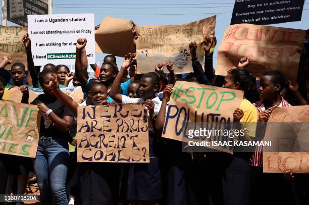 Students hold placards during a strike as part of a global day of student protests aiming to spark world leaders into action on climate change at...