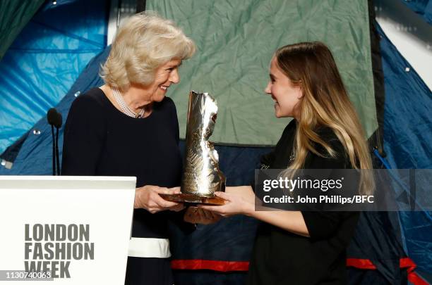 Camilla, Duchess Of Cornwall awards the Queen Elizabeth II award for British Design to designer Bethany Williams at the Bethany Williams show during...