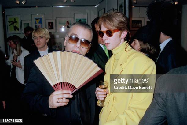German fashion designer Karl Lagerfeld with milliner Philip Treacy, at a celebrity party given by the Versace company, London, 14th May 1991.