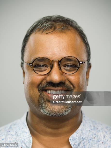 real indian mature man with happy expression and toothy smile - chubby arab stock pictures, royalty-free photos & images