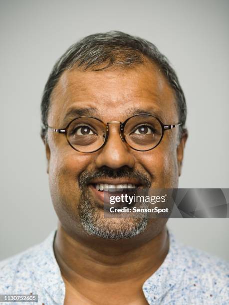 real indian mature man with excited expression looking up - fat asian man stock pictures, royalty-free photos & images