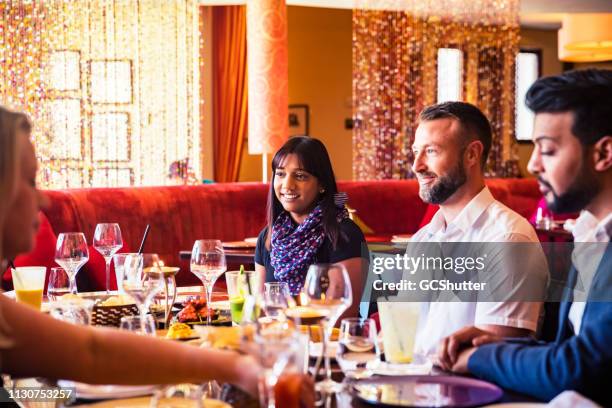 group of friends spending time together at a fine dining restaurant - middle east friends stock pictures, royalty-free photos & images