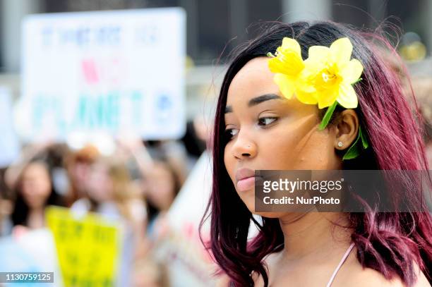 Student Kaylynn Medley wears an artificial flower in her hair as she participates in a climate strike inspired by the activism of 16 year old Swedish...