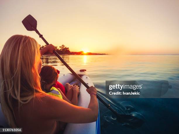 kayaking on the sea at sunset with child - ocean kayak stock pictures, royalty-free photos & images