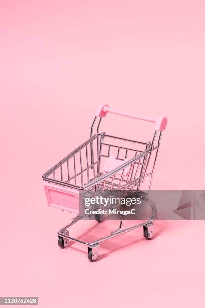 metallic small shopping cart on pink - abandoned cart stock pictures, royalty-free photos & images