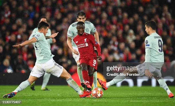 Naby Keita of Liverpool is challenged by James Rodriguez and Robert Lewandowski of Bayern Munich during the UEFA Champions League Round of 16 First...