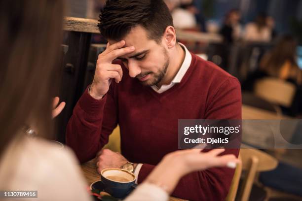 young couple having a serious discussion. - annoyed wife stock pictures, royalty-free photos & images